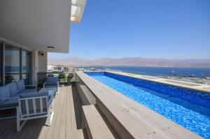 a large swimming pool with a view of the water at YalaRent Mountainside Duplexes with Private Pool in Eilat