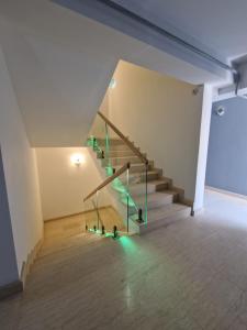 a staircase in a building with green lights at Apart HOTEL Fusion Tower in Iaşi