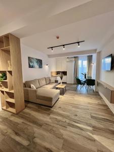 a living room with a couch and a table at Atmosphere by the Sea in Eforie Nord +79 photos
