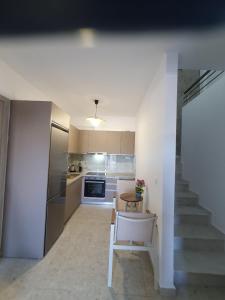a kitchen with a staircase and a table in a room at Momo's House in Nikiti