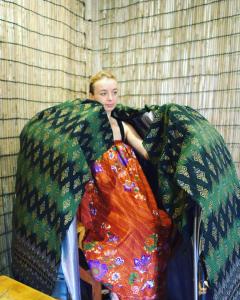 暹粒的住宿－Hostel Goen -Japanese hostel-，一个小女孩坐在一堆毯子里