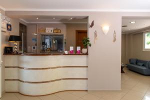 a lobby of a hospital with a reception counter at Anemona Beach Hotel in Argasi
