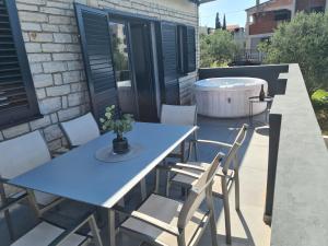 a blue table and chairs on a patio with a tub at Harmony Home in Drage
