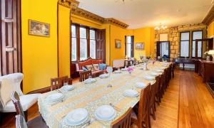 a large long table in a room with yellow walls at Harvieston Hall in Gorebridge