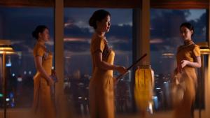 a group of three women standing in front of a window at The Ritz-Carlton Shanghai, Pudong in Shanghai