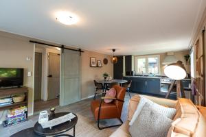 a living room with a couch and a table at Nature hideout at Veluwe nature park in Putten