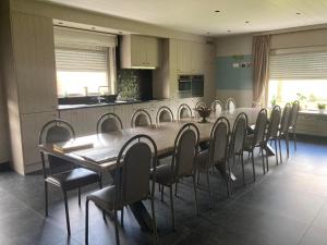 a dining room with a long table and chairs at Hill44 in Zonnebeke