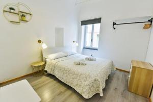 a white bedroom with a bed and a window at Welcome Varigotti - Borgo Saraceno - Libeccio in Varigotti