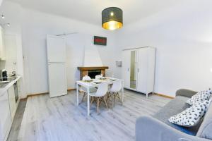 a kitchen and a living room with a table and a couch at Welcome Varigotti - Borgo Saraceno - Libeccio in Varigotti