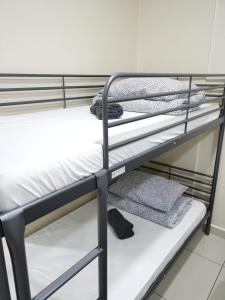 a couple of bunk beds in a room at ●T11●2Pax●Studio●5min●Queensbay●Pg Bridge View● in Bayan Lepas