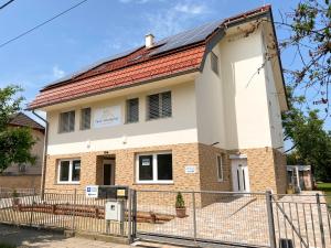 a building with a fence in front of it at Fasor Vendégház in Szeged