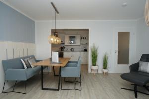 a living room with a dining room table and chairs at Seeblick - a57219 in Cuxhaven