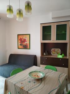a living room with a table and a couch at Bilo Olivieri Porto Cesareo in Porto Cesareo