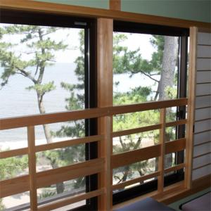 a window in a room with a view of the ocean at Nisshokan in Ise