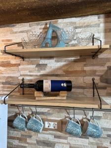 a bottle of wine and glasses on a shelf at Carpe diem Baška in Baška