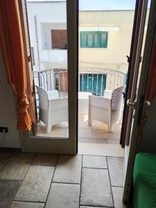 an open door with a view of a balcony at Bilo Olivieri Porto Cesareo in Porto Cesareo