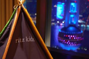 a tent kitties sign in front of a window at The Ritz-Carlton Shanghai, Pudong in Shanghai