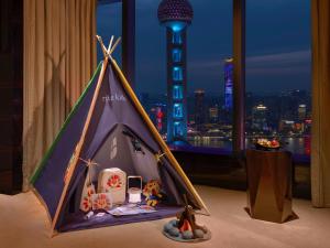 a tent in a room with a view of a city at The Ritz-Carlton Shanghai, Pudong in Shanghai