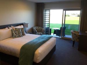 a hotel room with a bed and a large window at East Pier Hotel in Napier