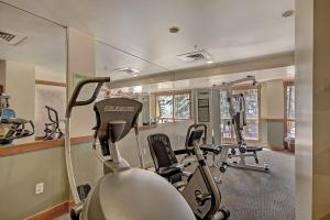 a gym with several treadmills and elliptical machines at 8912 The Springs Condo in Keystone