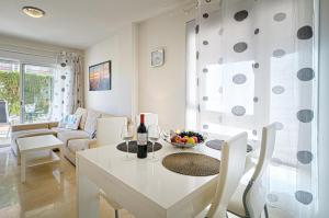 - un salon avec une table et des chaises blanches dans l'établissement Estrella 2 3 Bh, à L'Alfas del Pi