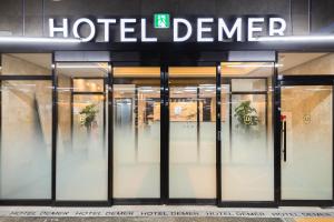 a store front with glass doors and a hotel cleaner sign at Hotel Demer Mokpo in Mokpo