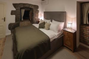 a bedroom with a large bed and a mirror at Villa Fani with Jacuzzi in Ičići +62 photos