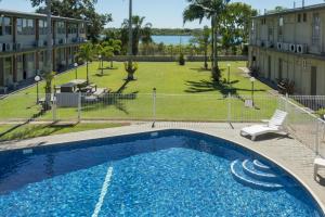 a large blue swimming pool next to a building at Mid City Motor Inn in Mackay