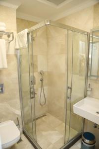 uma casa de banho com um chuveiro, um WC e um lavatório. em Novus Hotel İstanbul em Istambul