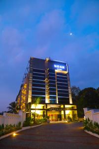 a hotel with a sign on the front of it at Noah Sky Suites in Cochin