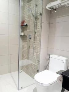a bathroom with a toilet and a glass shower at Căn hộ Condotel 5 sao Apec Mandala Phú Yên in Tuy Hoa +10 photos