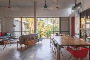 a living room with a wooden table and chairs at RedBox House - Private Luxury Modern Style 5 Bedrooms Villa in Siem Reap