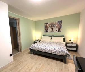 a bedroom with a bed and two night stands with lamps at Al BORGO costermano sul garda via pertica 8A in Costermano sul Garda
