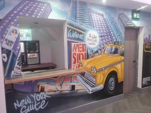 a room with a painting of a truck on the wall at The White House New York Suites in Blackpool