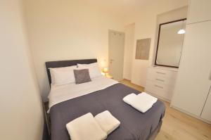 a bedroom with a large bed with two pillows at Villa Eoli Corfu in Ágios Prokópios