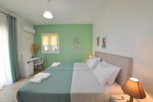 ein Schlafzimmer mit einem großen Bett und einem Schreibtisch in der Unterkunft Villa Eoli Corfu in Ágios Prokópios