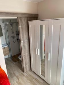 a bathroom with a shower and a toilet in it at Alka in Mielno +40 photos