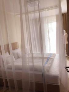 two beds with white curtains in a bedroom at Sunset Resort 311 in Fonyód