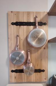 a bathroom with two copper sinks on a wooden wall at Sunset Resort 311 in Fonyód