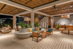 a lobby with a couch and chairs and a table at Aldiana Club Zanzibar Kwanza in Kizimkazi