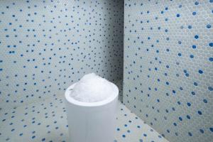 a white pillar in a room with a wall with blue dots at Aldiana Club Zanzibar Kwanza in Kizimkazi
