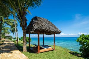 a hut on the beach near the ocean at Aldiana Club Zanzibar Kwanza in Kizimkazi