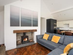 a living room with a couch and a fireplace at 13 Quay Street in Amlwch