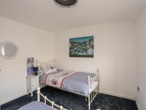 a bedroom with a bed and a picture on the wall at 13 Quay Street in Amlwch