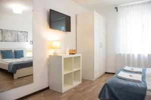 a bedroom with a bed and a tv on a wall at Csillagvirág Apartman Gyula in Gyula