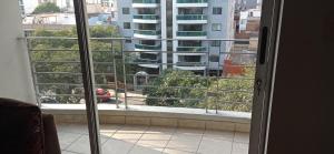 a window with a view of a building at Casa lelita in Lima