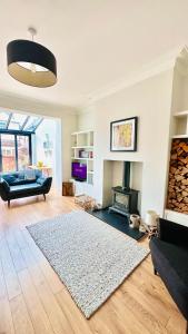 a living room with a couch and a fireplace at Sea Retreats, Whitley Bay, Sleeps 9 in Whitley Bay