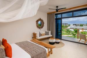 a bedroom with a bed and a view of the ocean at Aldiana Club Zanzibar Kwanza in Kizimkazi