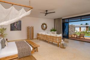 a bedroom with two beds and a large window at Aldiana Club Zanzibar Kwanza in Kizimkazi