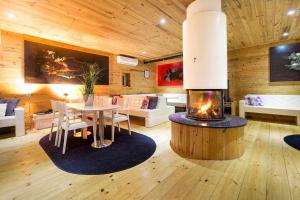a living room with a table and a fireplace at A Casa do Tio Tenente - Casa Toda in Ermida